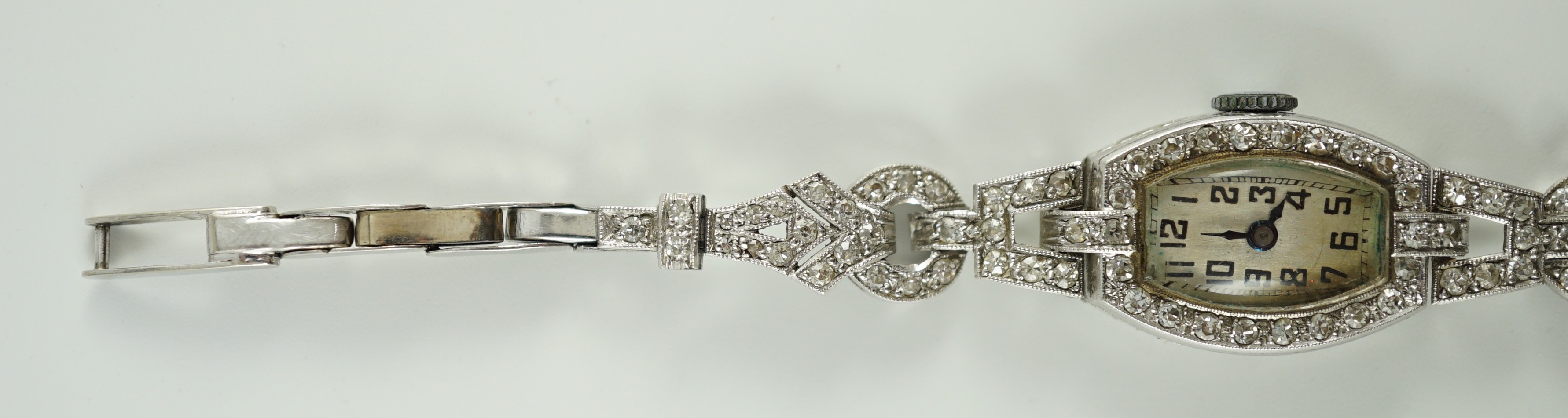 A lady's 1920’s platinum and round brilliant cut diamond set manual wind cocktail watch, on a white gold expanding bracelet